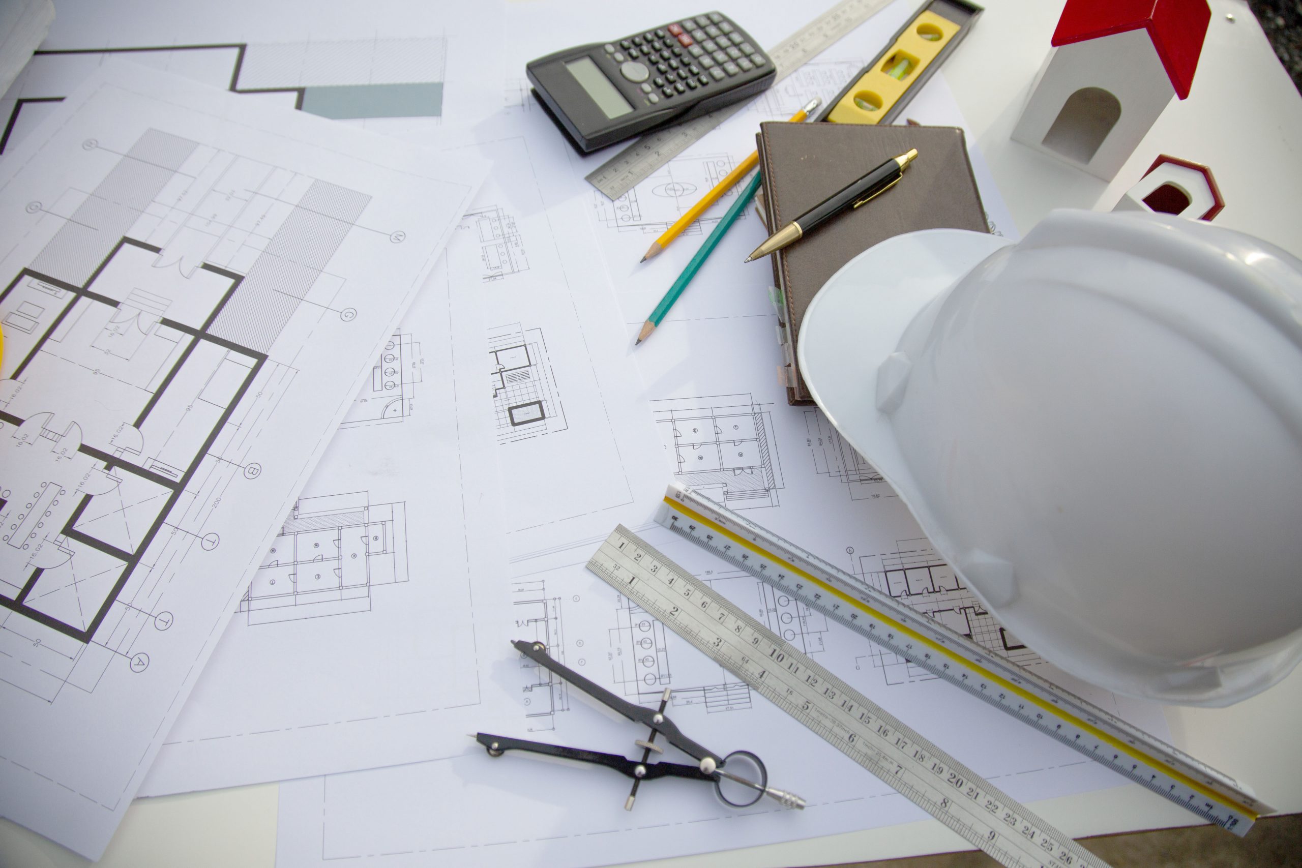 Desk of Architectural working project in construction site,With drawing equipment concept.